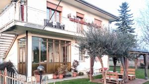 a white house with trees and a fence at Biogarden in Zelarino