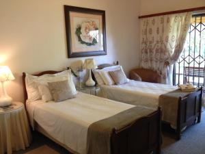 a hotel room with two beds and a window at The Nook B&B in Kimberley +25 photos
