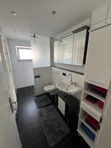 a small bathroom with a sink and a mirror at Ferienwohnung im Täle in Bad Überkingen