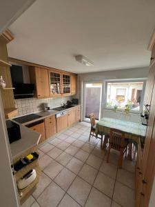 a kitchen with a table and chairs in it at Ferienwohnung im Täle in Bad Überkingen +2 photos