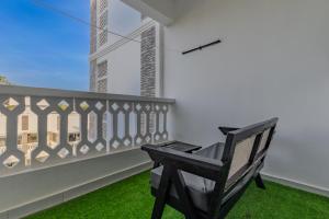 a bench on a balcony with a view of a building at Wendy's Da-Azizi Homes Diani in Diani Beach