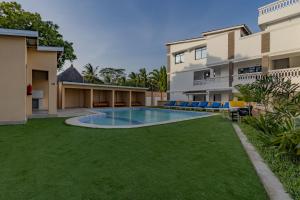an image of a swimming pool in the backyard of a house at Wendy's Da-Azizi Homes Diani in Diani Beach