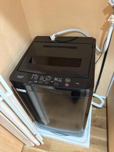 a microwave oven sitting on top of a wall at 一休居 in Osaka