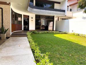 a large house with a lawn in front of it at BansriVilla Mount Lavinia in Mount Lavinia