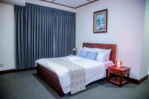a hotel room with a bed and a table with a candle at BansriVilla Mount Lavinia in Mount Lavinia
