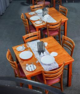 a wooden table with plates and napkins on it at BansriVilla Mount Lavinia in Mount Lavinia +33 photos