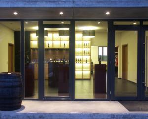 a store front with glass doors and a bar at Weingut Seck in Dolgesheim