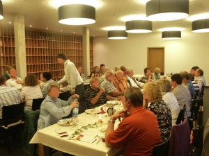 a group of people sitting at tables in a room at Weingut Seck in Dolgesheim