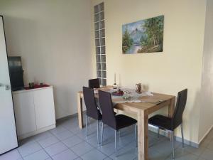 a dining room with a wooden table and chairs at Haras'house in Asvestokhórion +11 photos