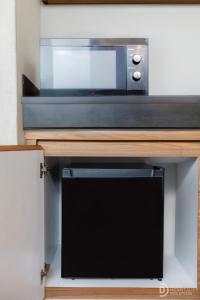 a microwave oven sitting on top of a wooden counter at ME Villa Pererenan in Canggu