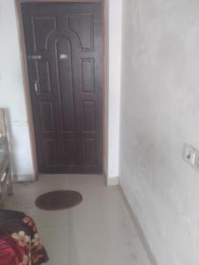 a room with a door with a rug in front of it at relief villa in Lucknow