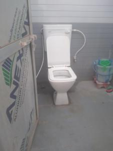 a bathroom with a white toilet in a room at relief villa in Lucknow