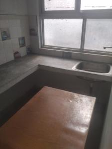 an empty kitchen with a sink and a window at relief villa in Lucknow