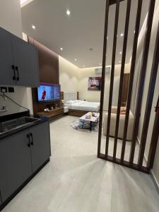 a large living room with a television and a living room at Nafel Modern Suite in Riyadh