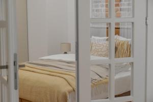 a bedroom with a bed with a glass door at HARBOR APARTMENTS - Mickiewicza in Katowice