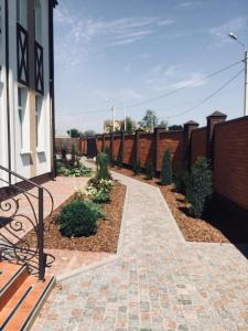 a patio with a bench next to a brick fence at BavariaHotel in Kharkiv