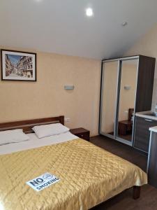 a hotel room with a bed with a sign on it at BavariaHotel in Kharkiv
