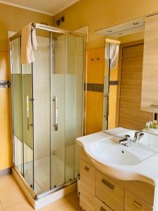 a bathroom with a sink and a shower at Locanda Munerato in Padova