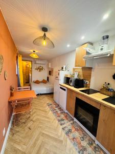 a kitchen with a table and a counter top at Gite du paradis in Le Luc