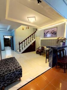 a living room with a bed and a staircase at Villa Bukit Asri Berastagi 08 in Berastagi