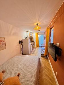 a small bedroom with a bed and a kitchen at Gite du paradis in Le Luc