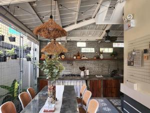 a kitchen with a table with chairs and a counter at Soak Screen Urban Hideaway in Iloilo City