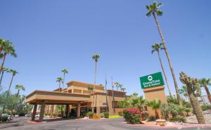 a view of a hotel with palm trees at GreenTree Inn & Suites Phoenix Sky Harbor in Phoenix