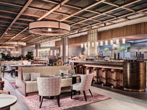a restaurant with tables and chairs and a bar at Radisson Collection Hotel, Berlin in Berlin