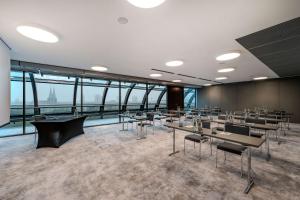 a large room with tables and chairs and windows at Radisson Collection Hotel, Berlin in Berlin +205 photos