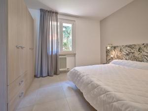 a bedroom with a large bed and a window at Residence Green Park in Torri del Benaco +36 photos