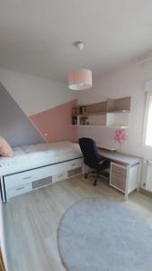 a bedroom with a bed and a desk and a chair at El Encanto de Valladolid in Aldeamayor de San Martín +15 photos