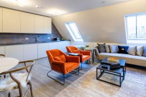 a living room with a couch and chairs and a table at Arran Shores Luxury Shorefront Apartment 14 in Lamlash