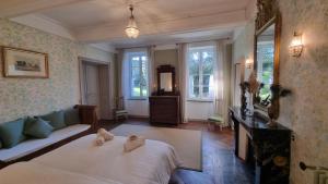 a bedroom with a bed and a couch and windows at Maison Barbaira in Barbaira +103 photos