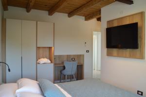 a living room with a couch and a tv on a wall at B&B Casa Anì in Pordenone