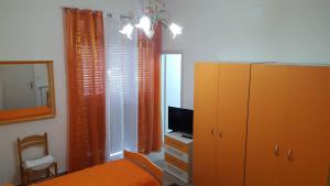 a bedroom with a bed and a dresser and a mirror at B&b Irma in Olivarella