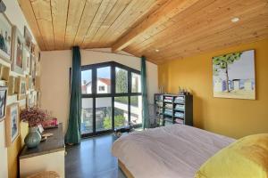a bedroom with a bed and a large window at Maison d'architecte 4 chambres avec piscine in Anglet +14 photos