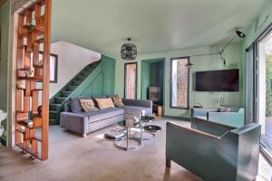 a living room with a couch and a staircase at Maison d'architecte 4 chambres avec piscine in Anglet