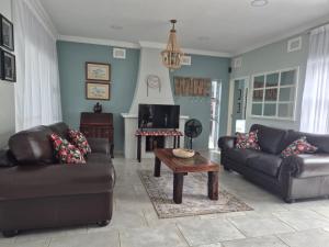 a living room with two couches and a coffee table at Malibu Waters in Port Edward