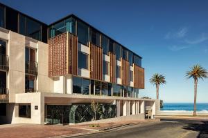 an office building with the ocean in the background at Morea House, Autograph Collection in Cape Town