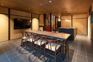a large dining room with a table and chairs at Guesthouse Hana - Harmony Villa in Kyoto
