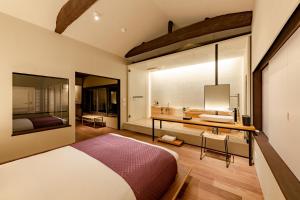 a bedroom with a bed and a sink and a mirror at Guesthouse Hana - Harmony Villa in Kyoto