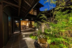 an exterior view of a house with a garden at night at Guesthouse Hana - Harmony Villa in Kyoto