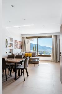 a living room with a couch and a table at Thea Villas in Makry Gialos