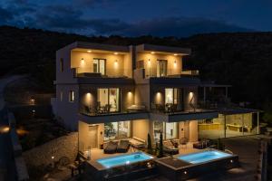 an aerial view of a house at night at Thea Villas in Makry Gialos