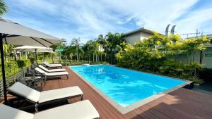 an image of a swimming pool in a house at Morino Hotel Si Racha in Si Racha