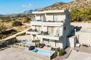 an aerial view of a house with a swimming pool at Thea Villas in Makry Gialos