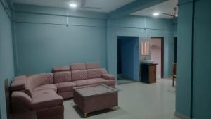 a living room with a couch and a table at The Siiying in Pāsighāt
