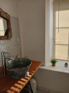 a bathroom with a bowl sink on a counter at au calme a 2pas des côtes du finistere sud in Bannalec +7 photos
