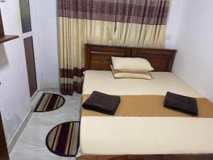 a small bedroom with two beds with towels on them at Lake Edge Hotel Polonnaruwa in Polonnaruwa