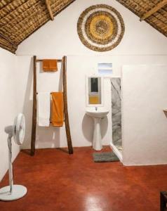 a bathroom with a sink and a toilet at MBOTY Village in Vohemar